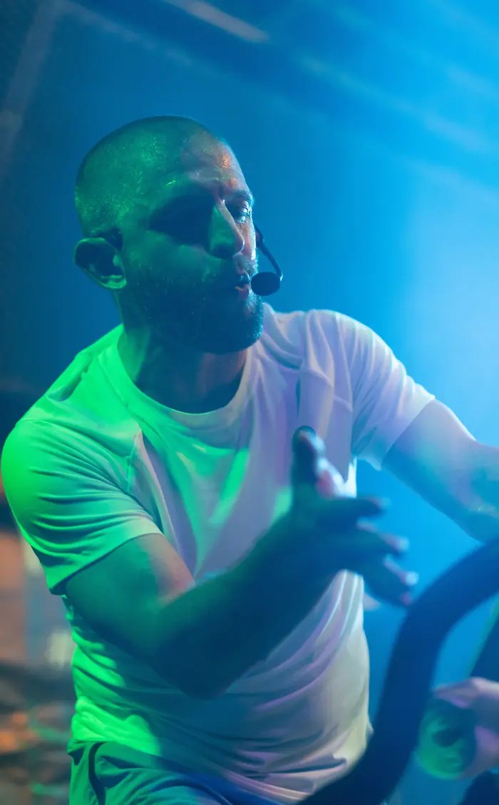 Dan Little presenting on stage with a headset microphone